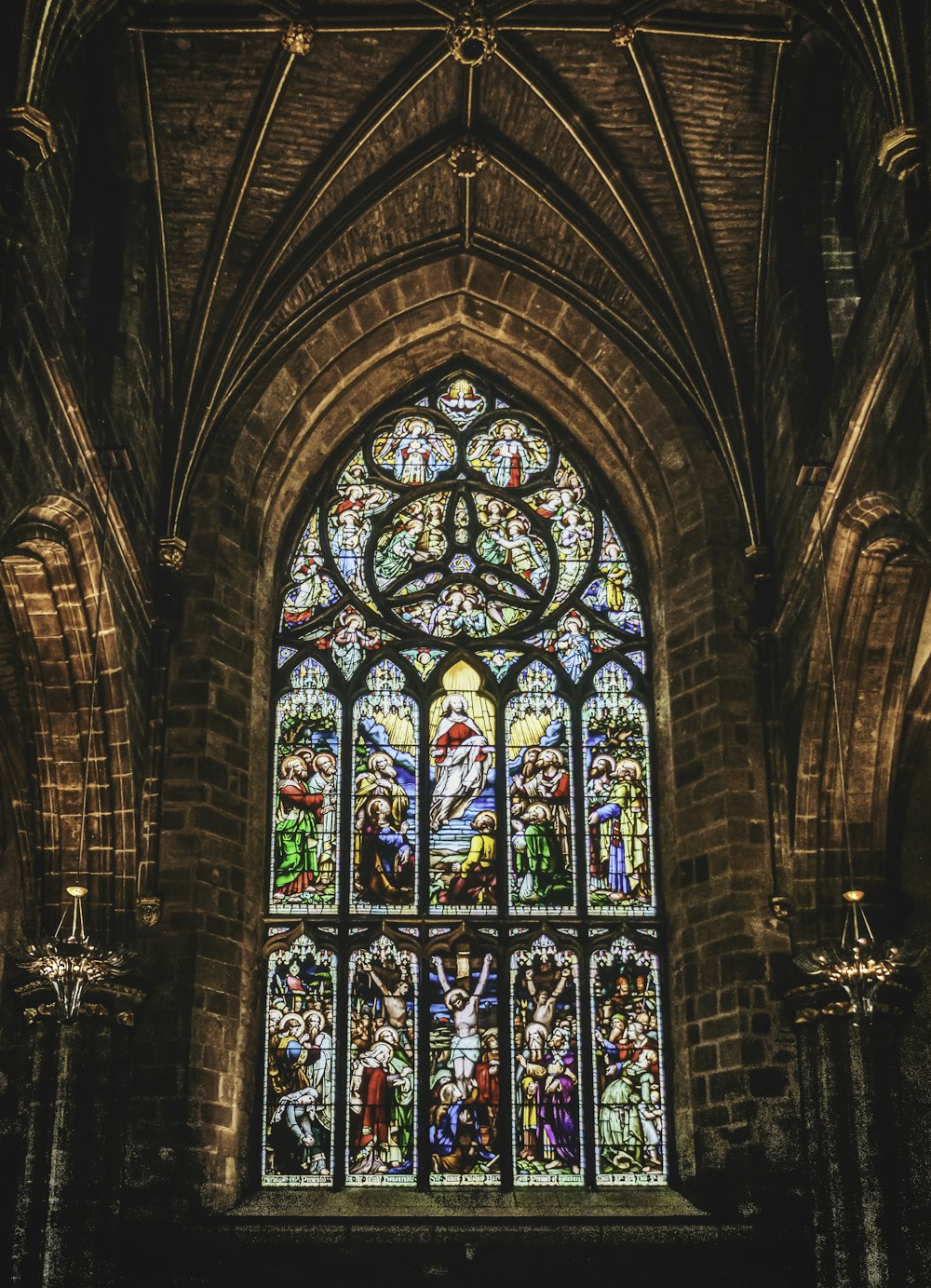 a large stained glass window inside of a church