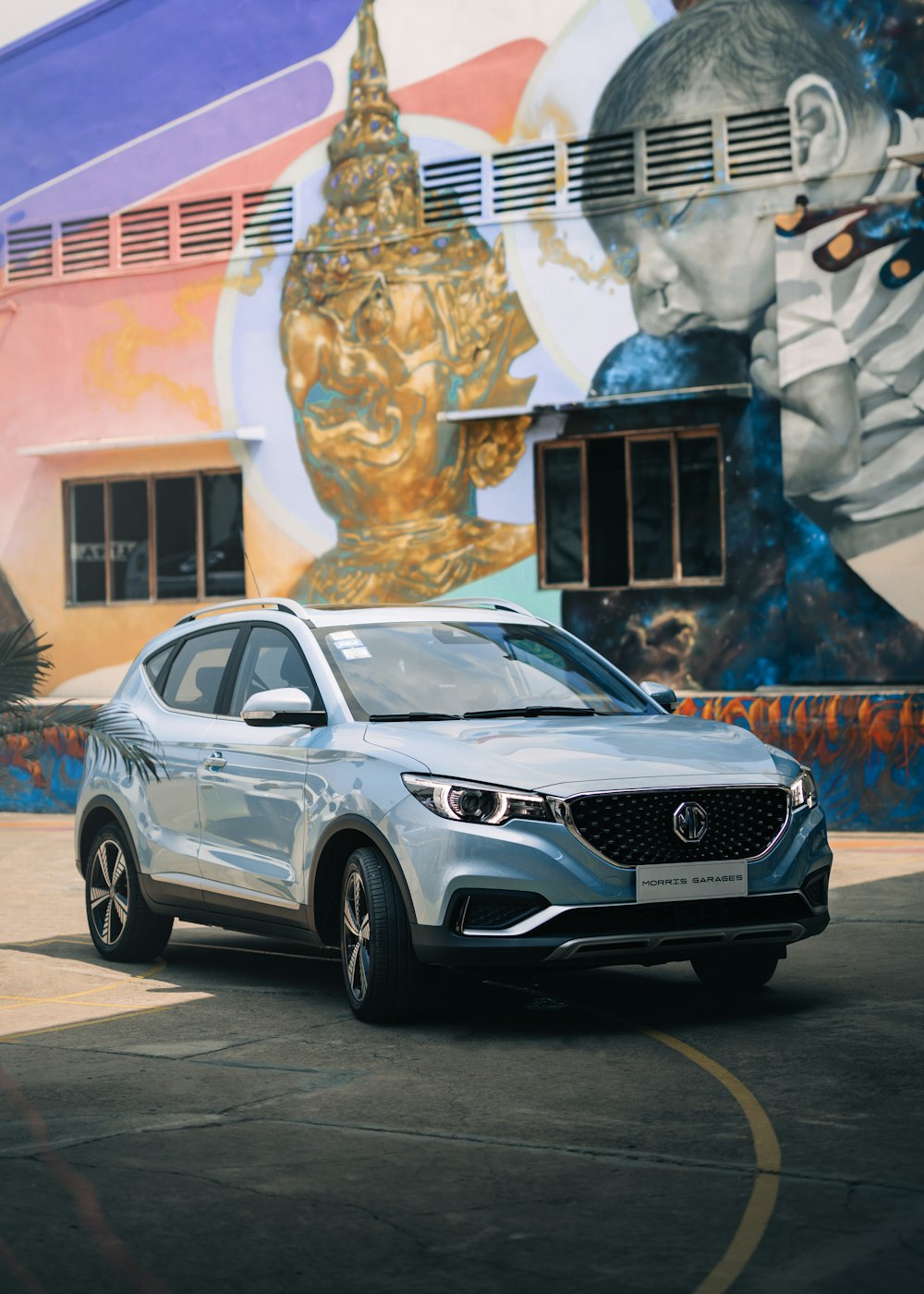 a silver car parked in front of a colorful building
