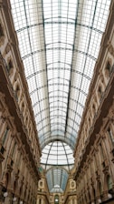 a large building with a glass ceiling and a clock on the wall
