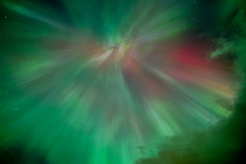a bright green and red aurora bore in the sky