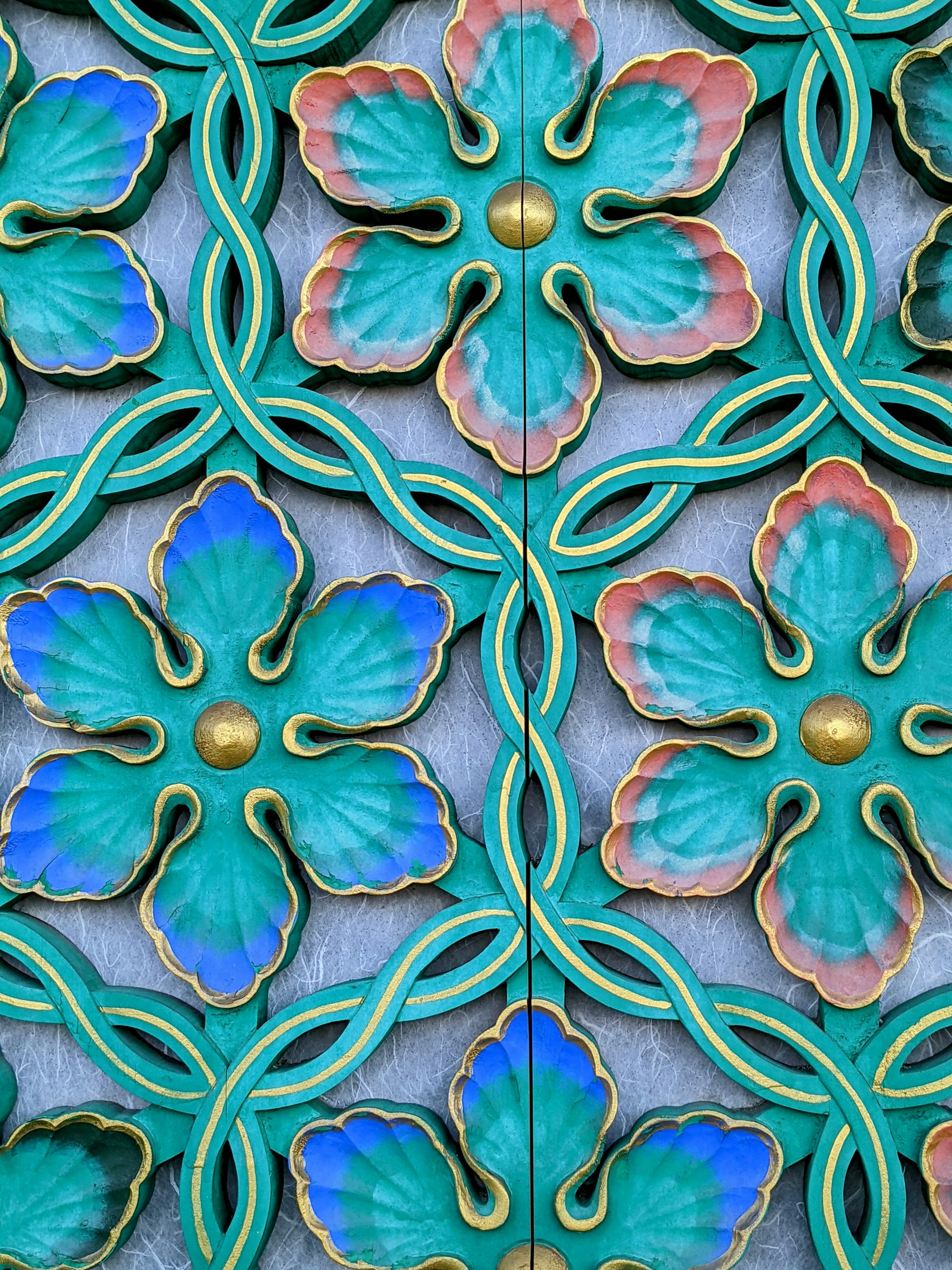 a close up of a decorative wall with flowers on it