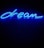 A bright blue neon sign displaying the word 'dream' written in cursive. The sign emits a glowing light against a dark background, creating a vibrant contrast.