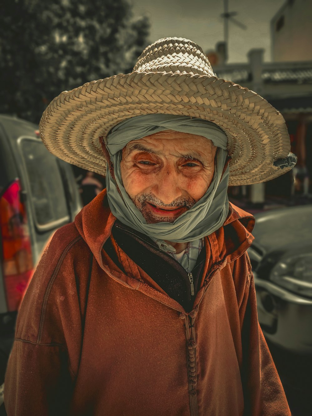 a man wearing a straw hat and a scarf