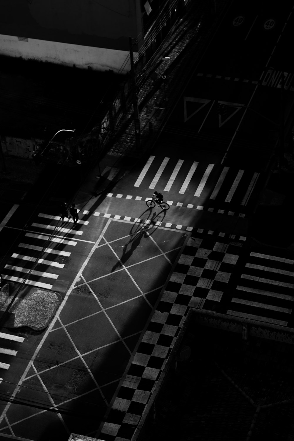 a man riding a bike across a cross walk