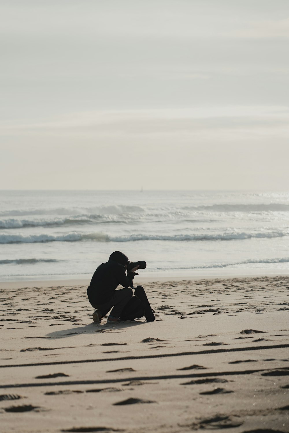 a person taking a picture on the beach