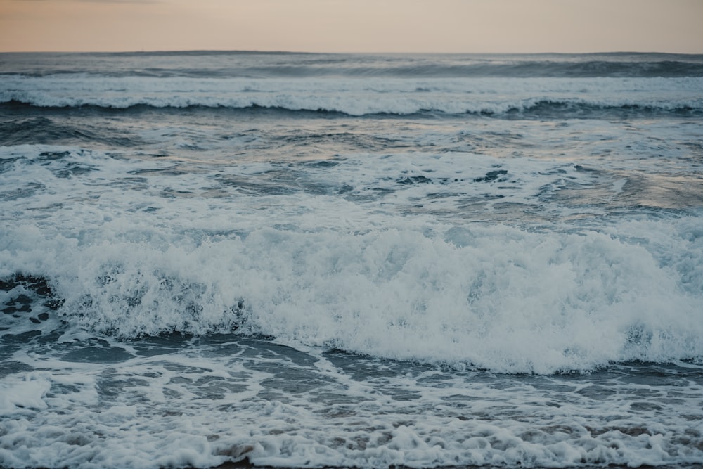 a large body of water with waves coming in to shore