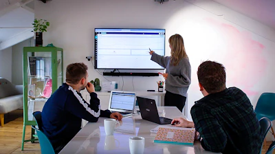 Team members discussing statistics results in a bright office setting.