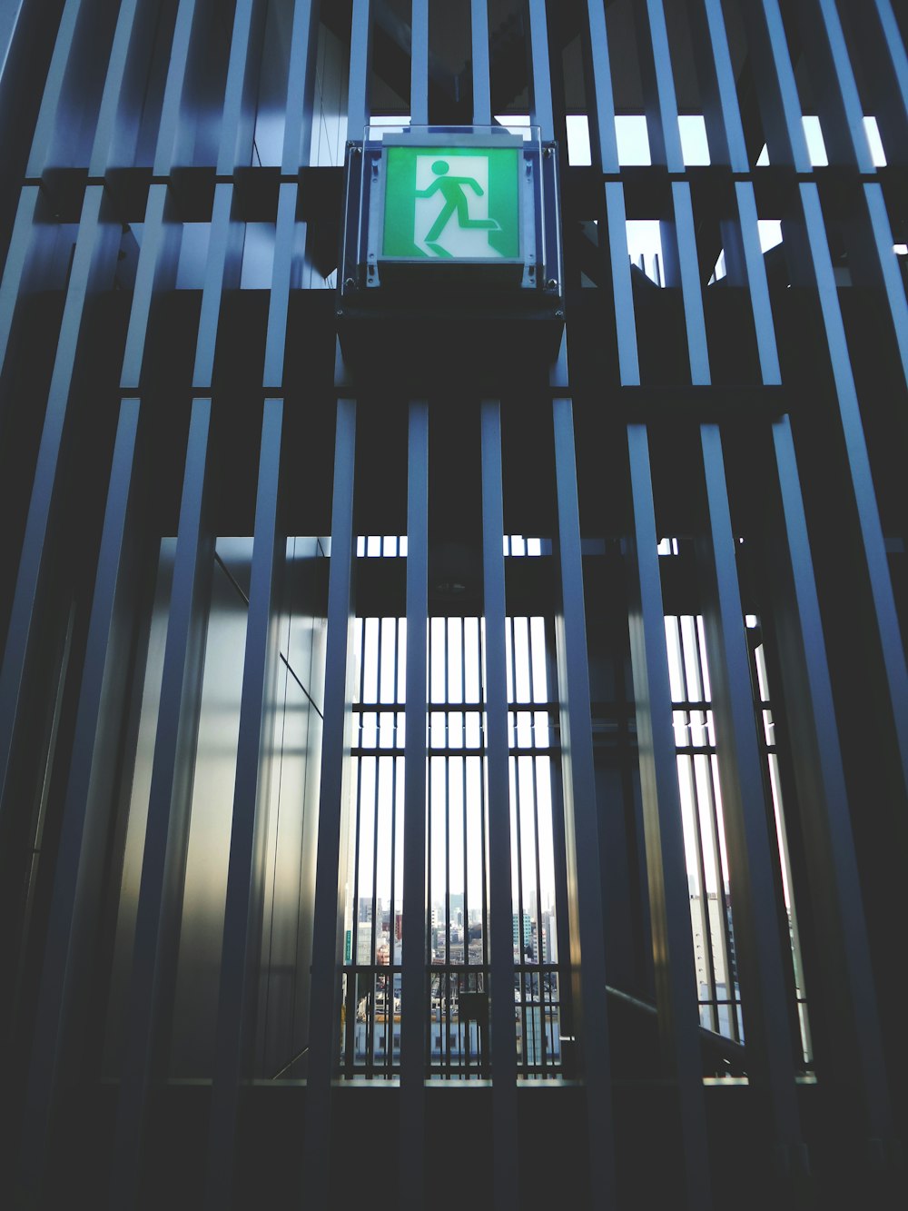 a green sign that is on the side of a building