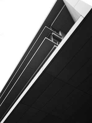 Minimalist architectural detail of a modern building with lines and shadows.