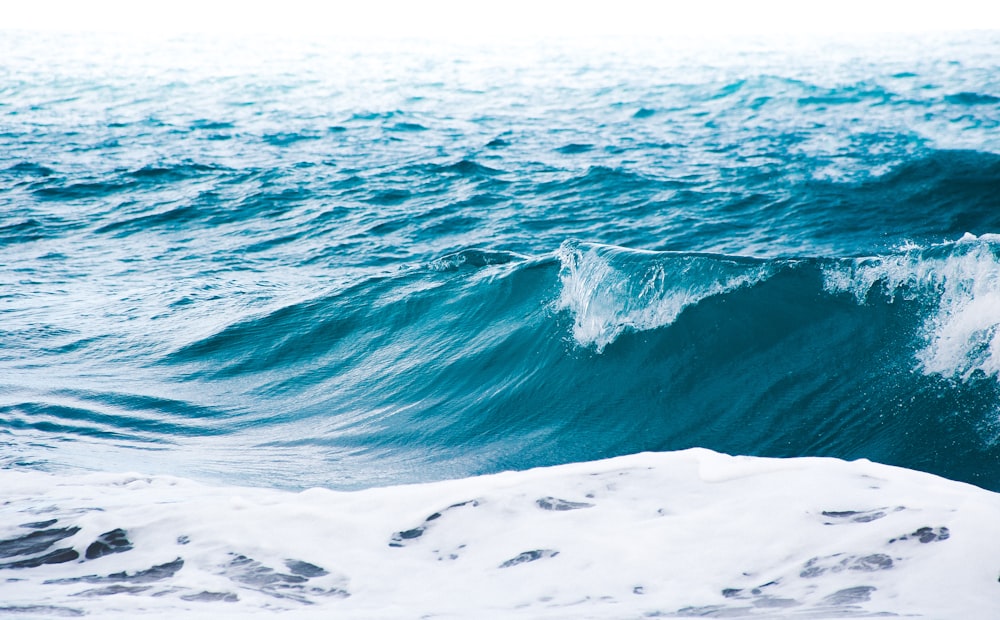 a person riding a surfboard on a wave in the ocean