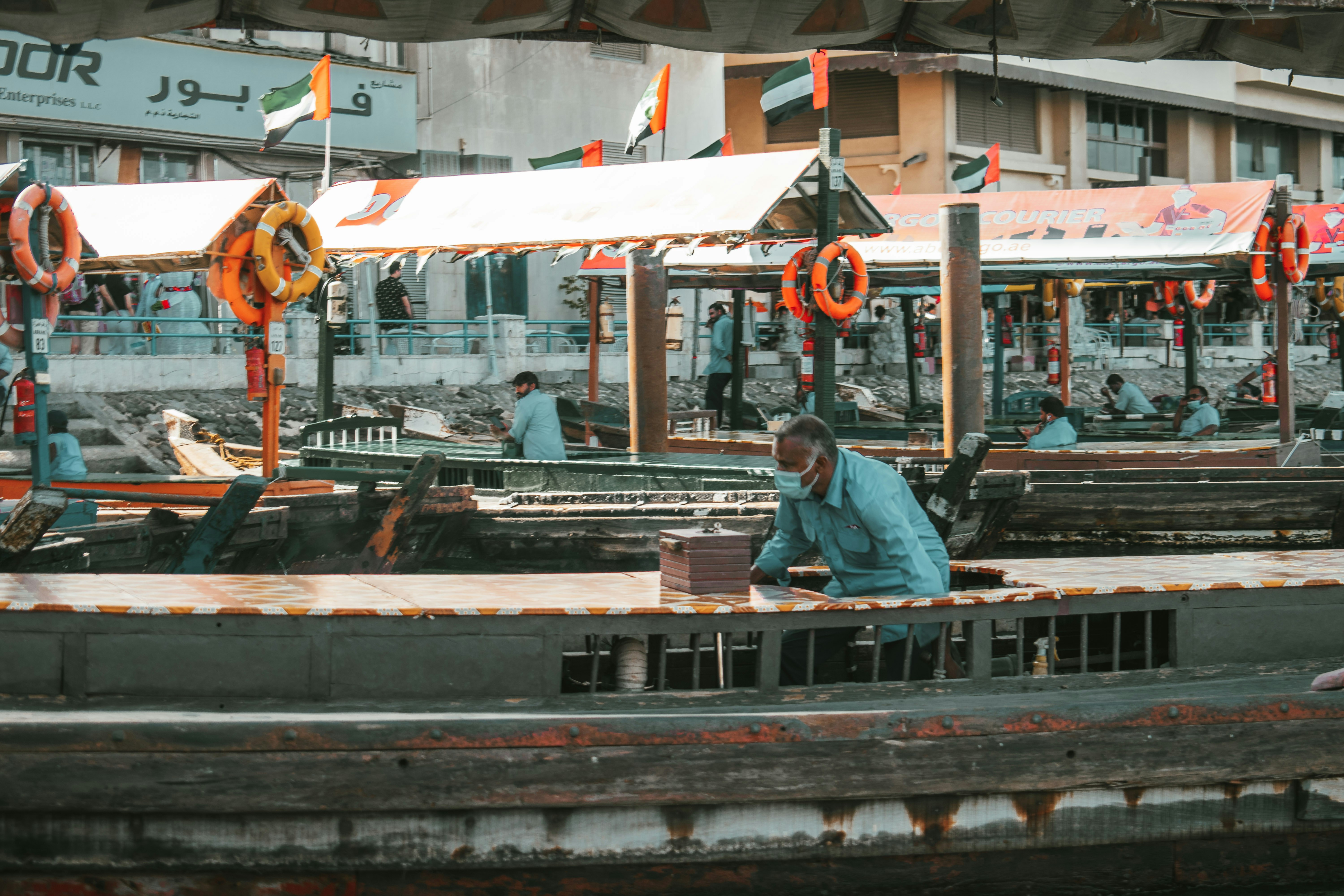 Indian sailors working diligently on the deck of a large merchant ship, wearing safety gear and looking professional.