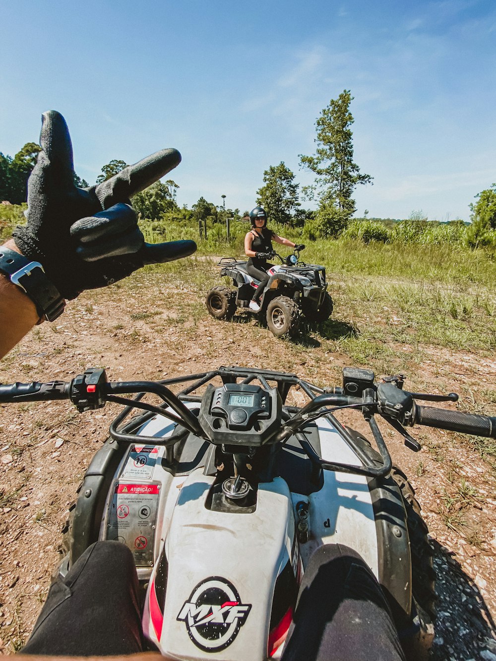 a motorcycle is parked on the side of a dirt field