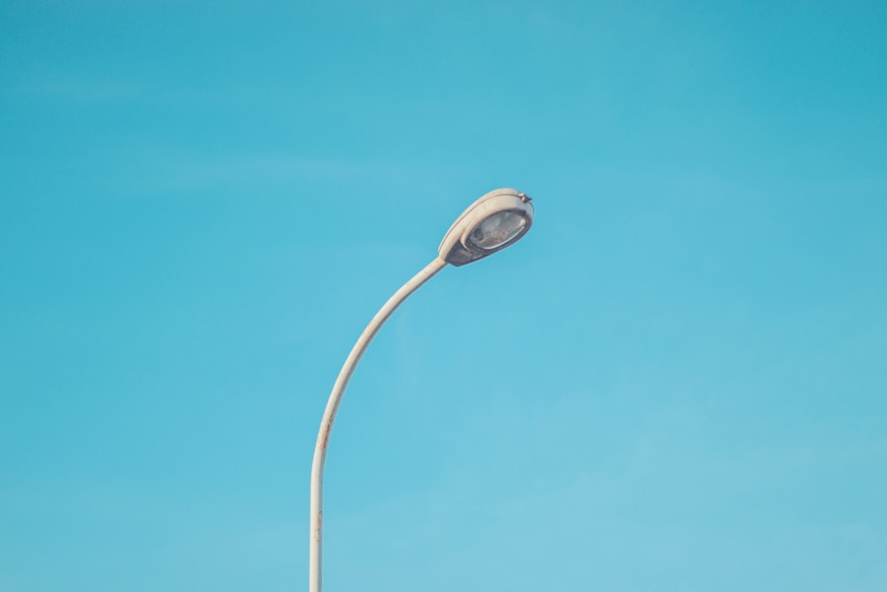 a street light with a blue sky in the background