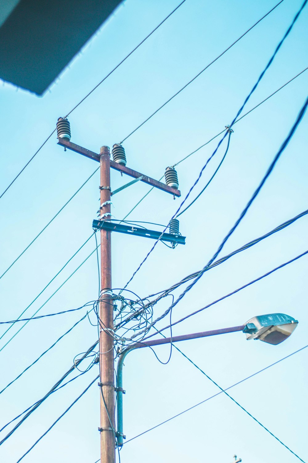 a telephone pole with a bunch of wires attached to it