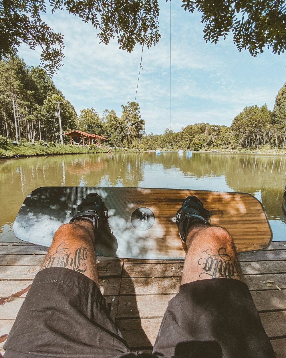 a person sitting on a bench next to a lake