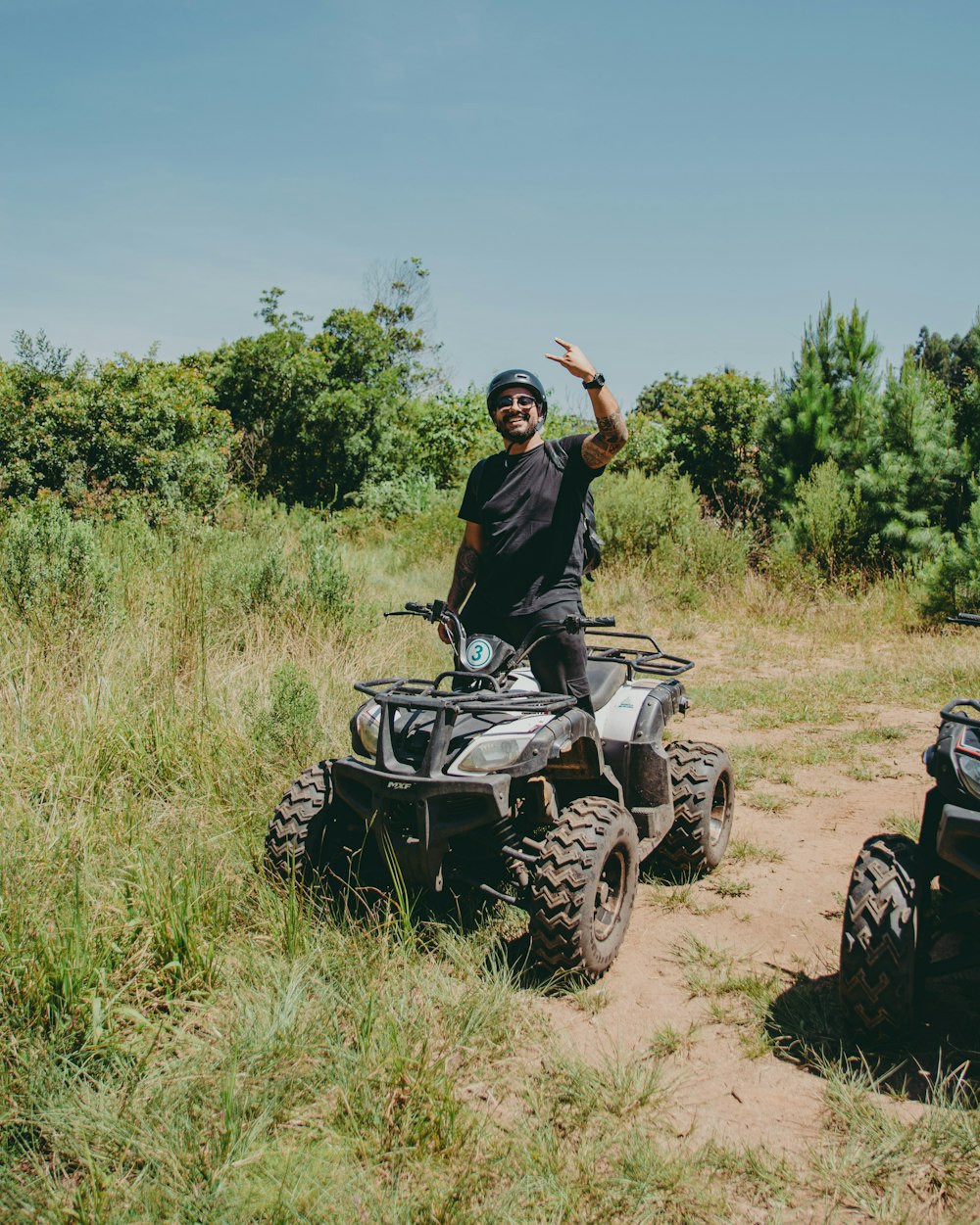 a man riding a motorcycle down a dirt road