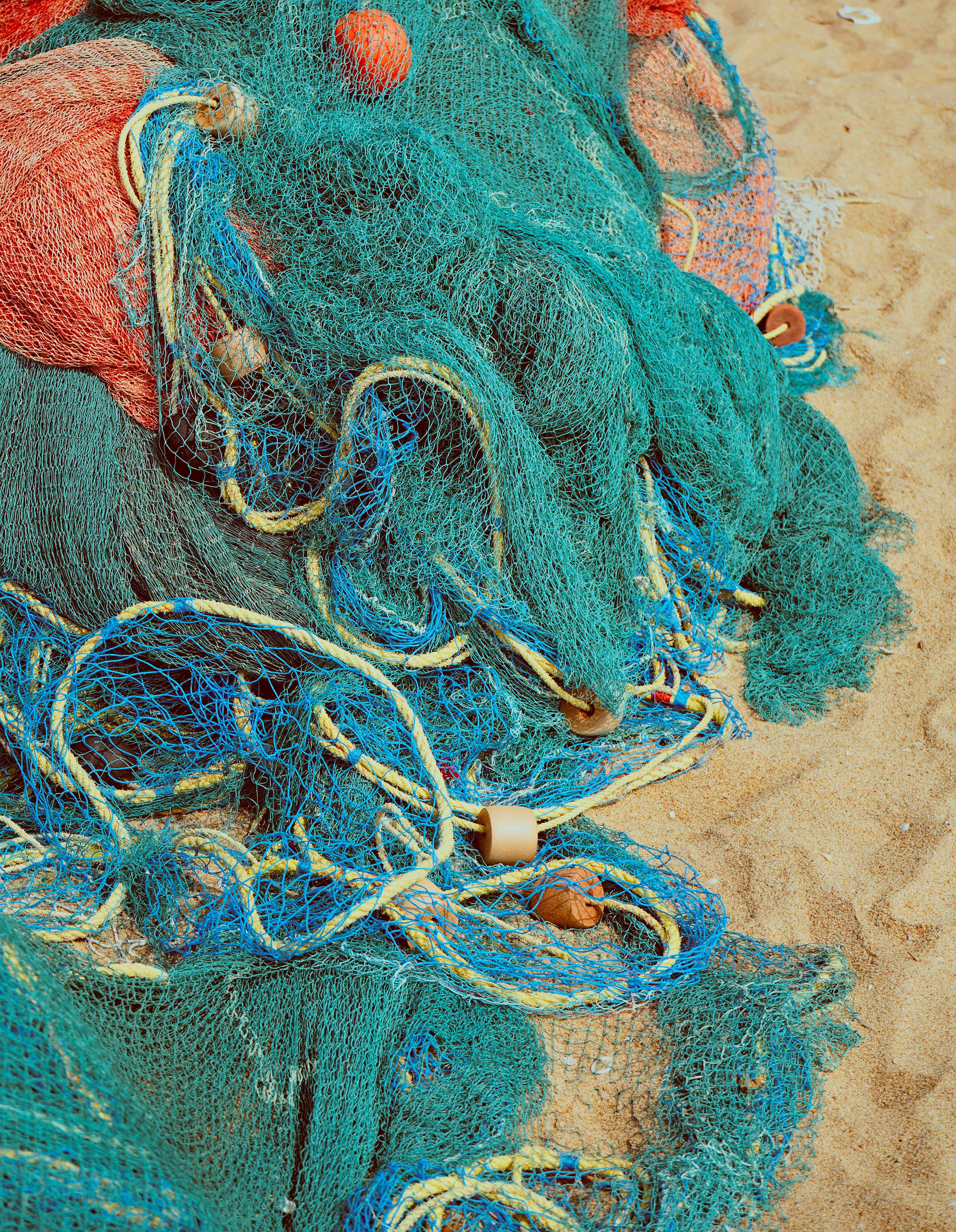 a pile of blue and red fishing nets