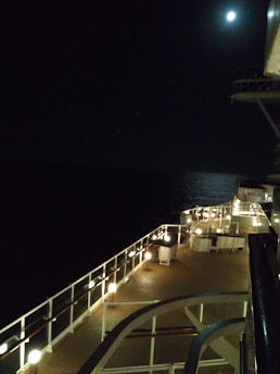 A classic ship light glowing softly against a wooden ship deck background.