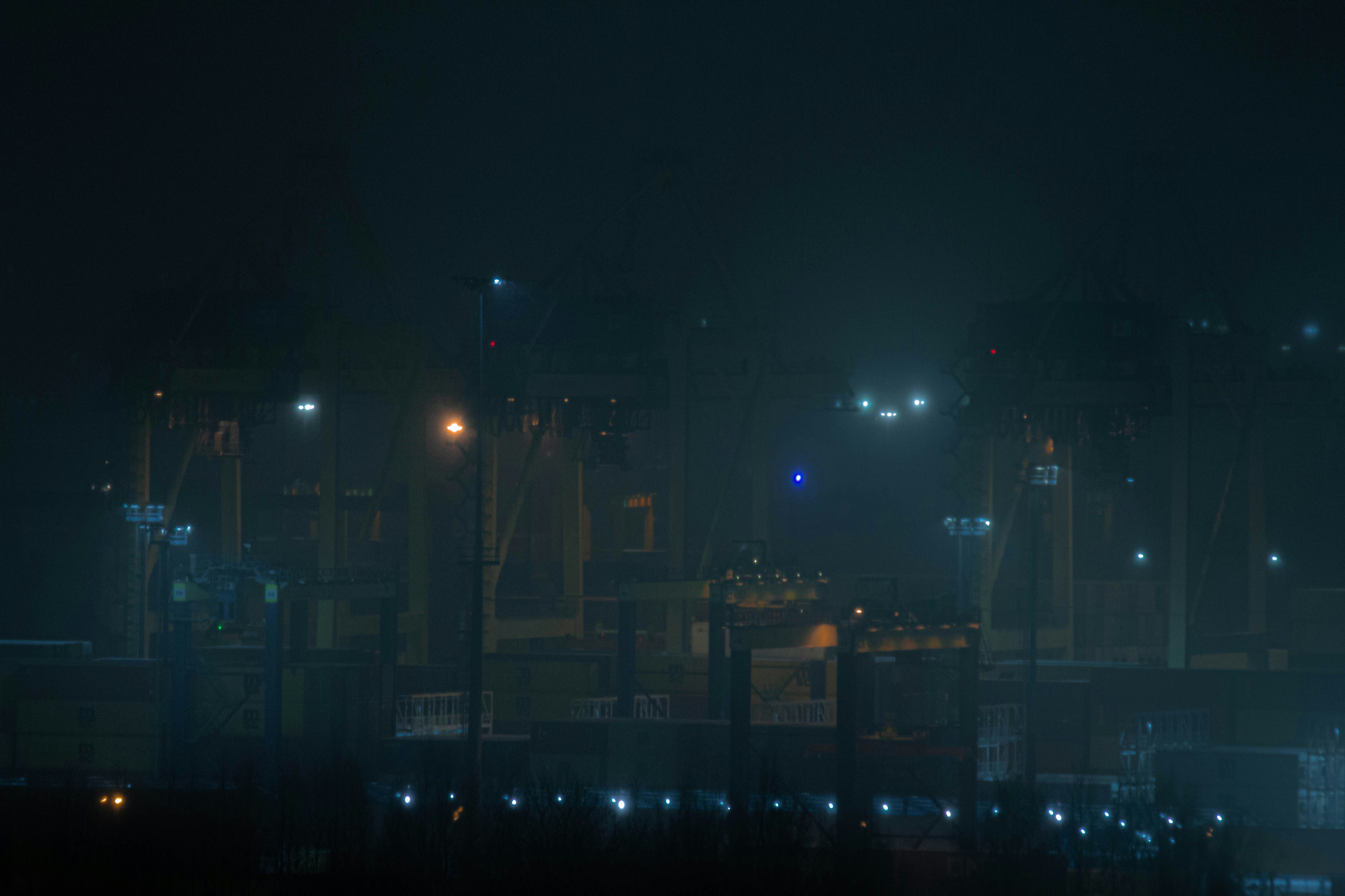 a city at night with street lights in the fog