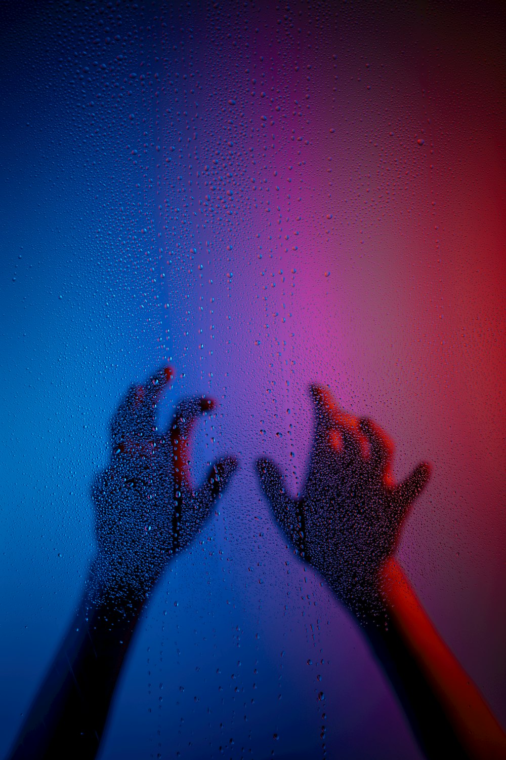 a person's hands are shown through a window