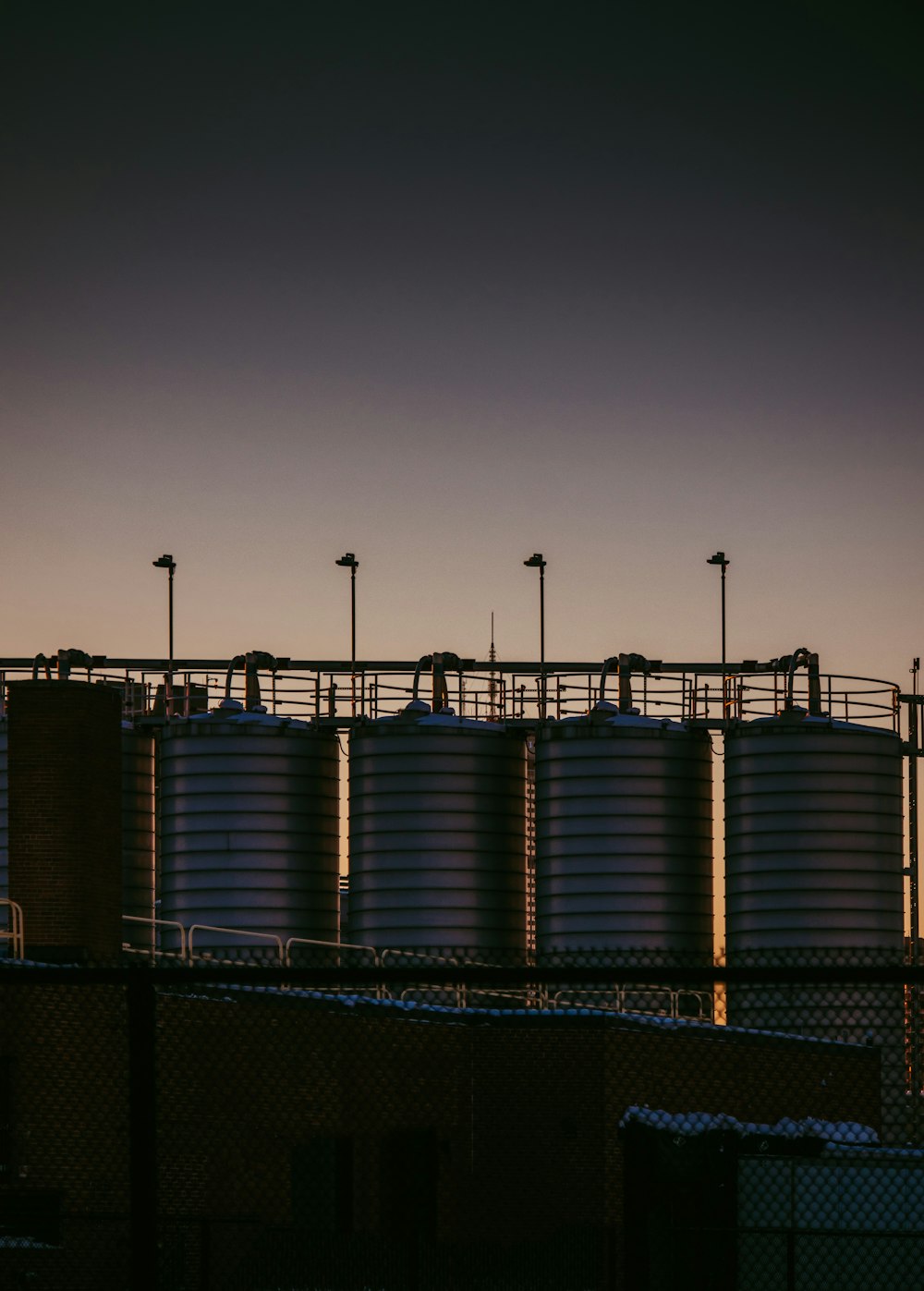 a row of tanks sitting on top of a fence