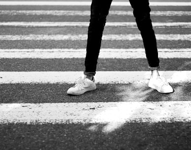 a person standing in the middle of a cross walk