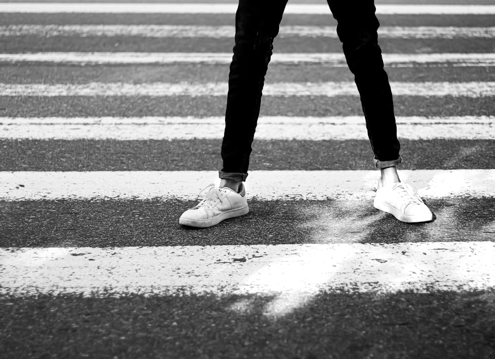 a person standing in the middle of a cross walk