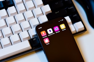 a cell phone sitting next to a keyboard