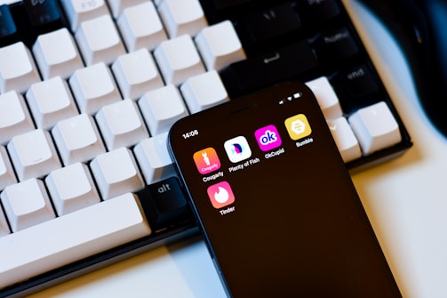 a cell phone sitting next to a keyboard