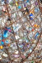 a large amount of plastic bottles in a wire basket
