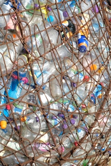 a large amount of plastic bottles in a wire basket