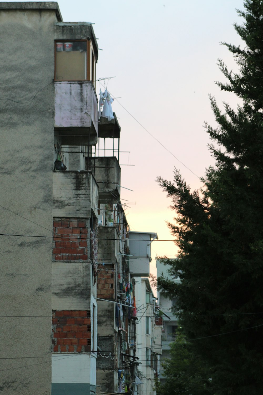 a tall building with lots of balconies on top of it