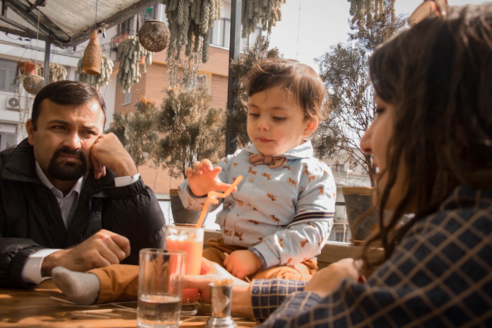 a man sitting at a table with a child