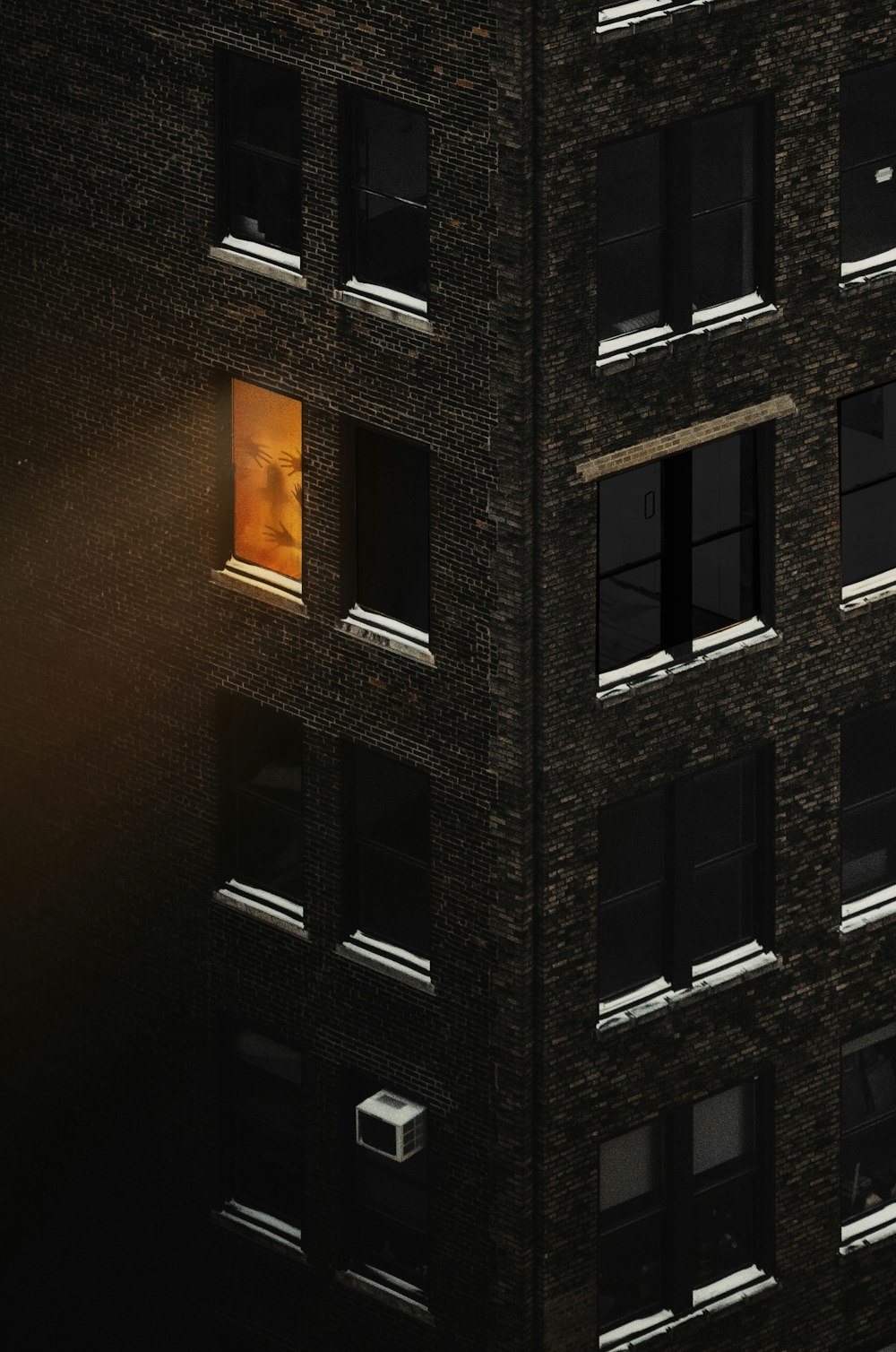 a tall building with windows and a street light