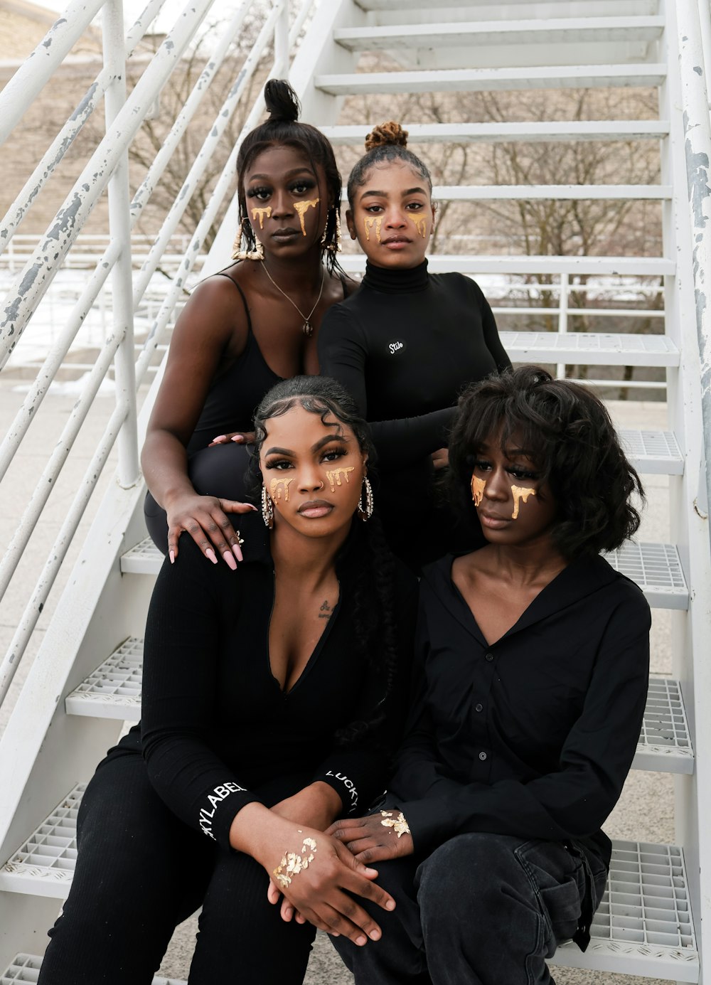 a group of women sitting on top of a set of stairs