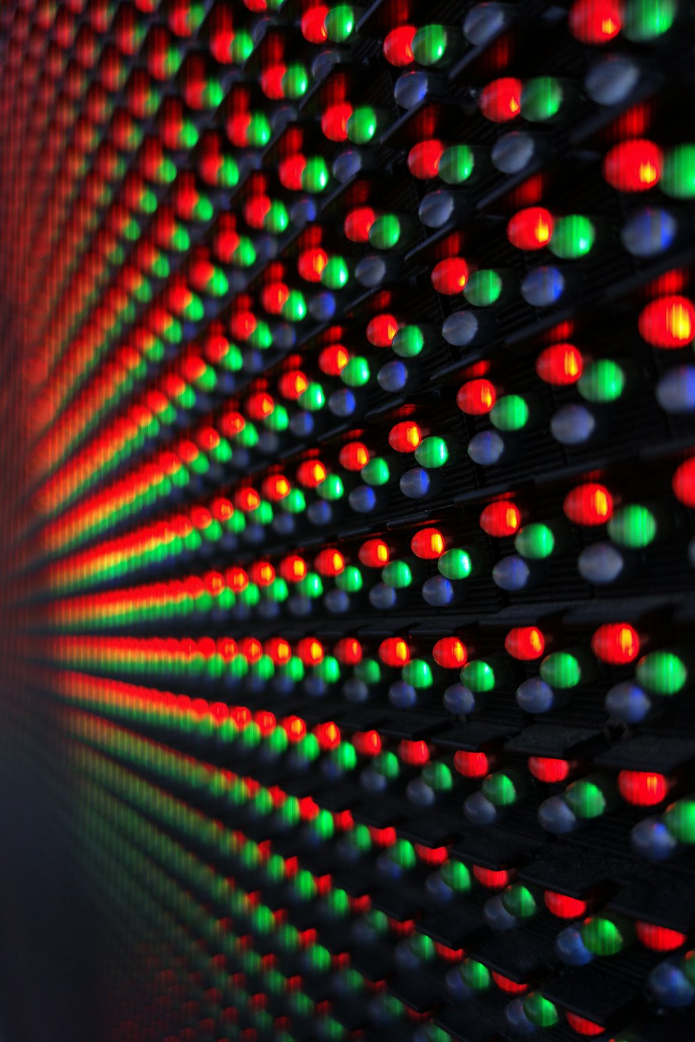 a close up of a wall with many different colored lights