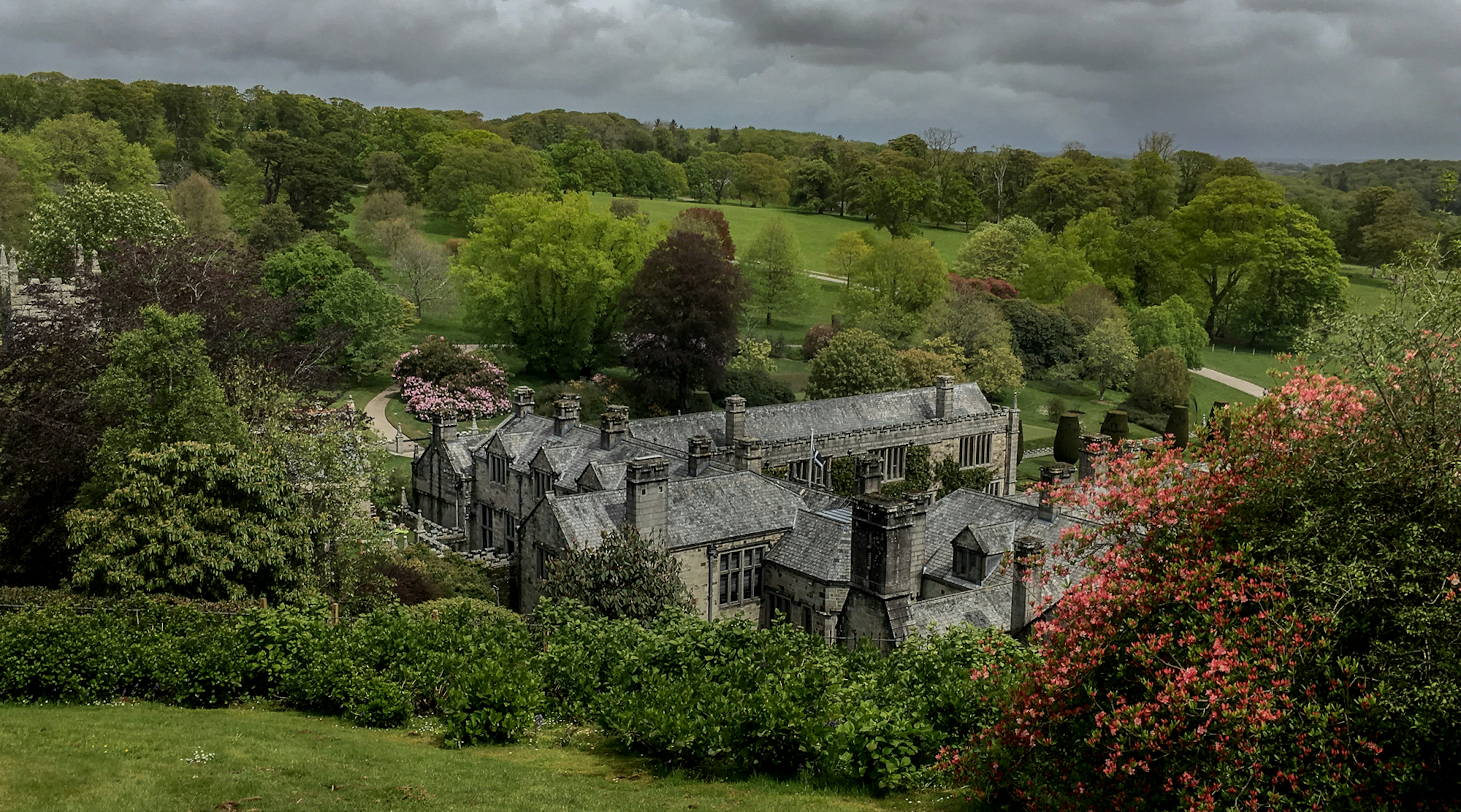 a large building sitting in the middle of a lush green field