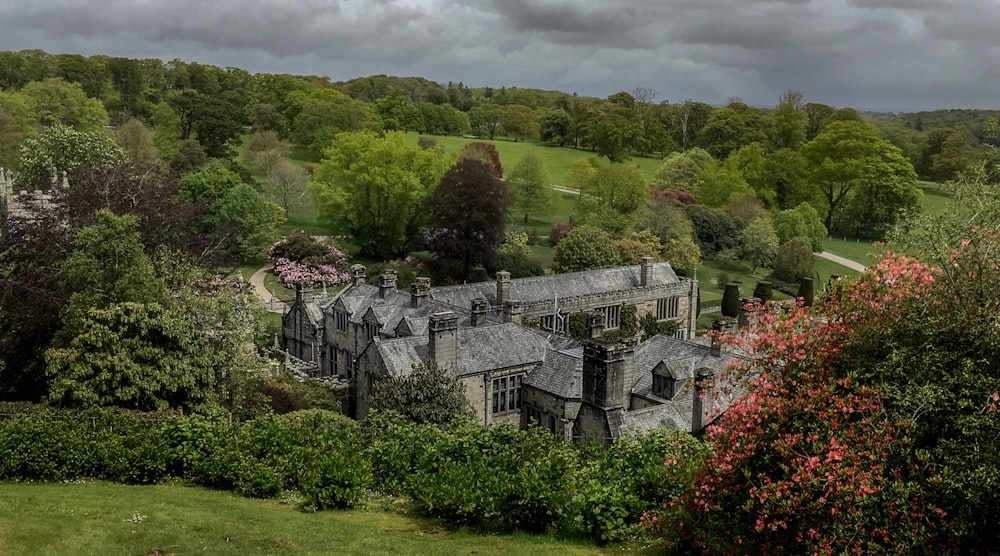 a large building sitting in the middle of a lush green field