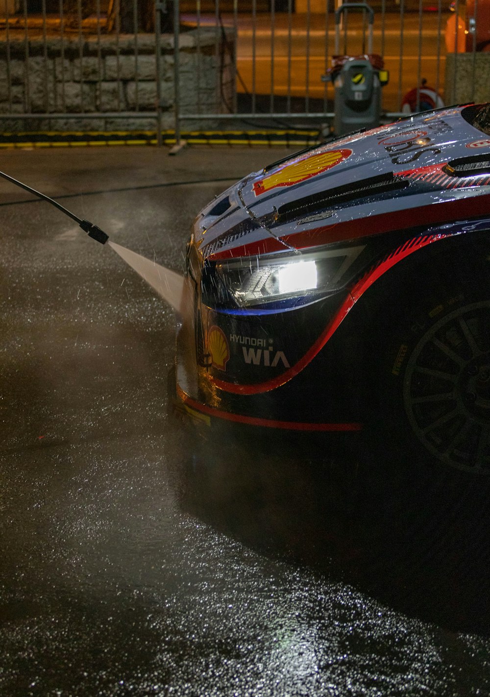 a man is washing a car with a high pressure washer