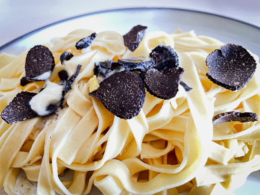 a plate of pasta with chocolate chips on top