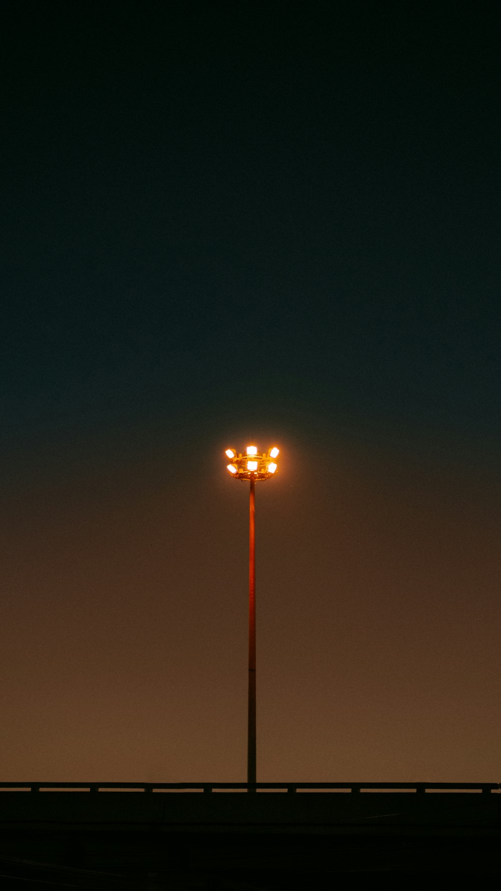 a street light sitting on the side of a road