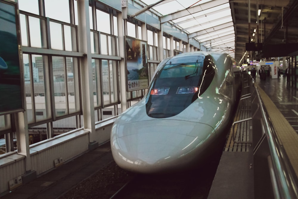 a bullet train sitting in a train station