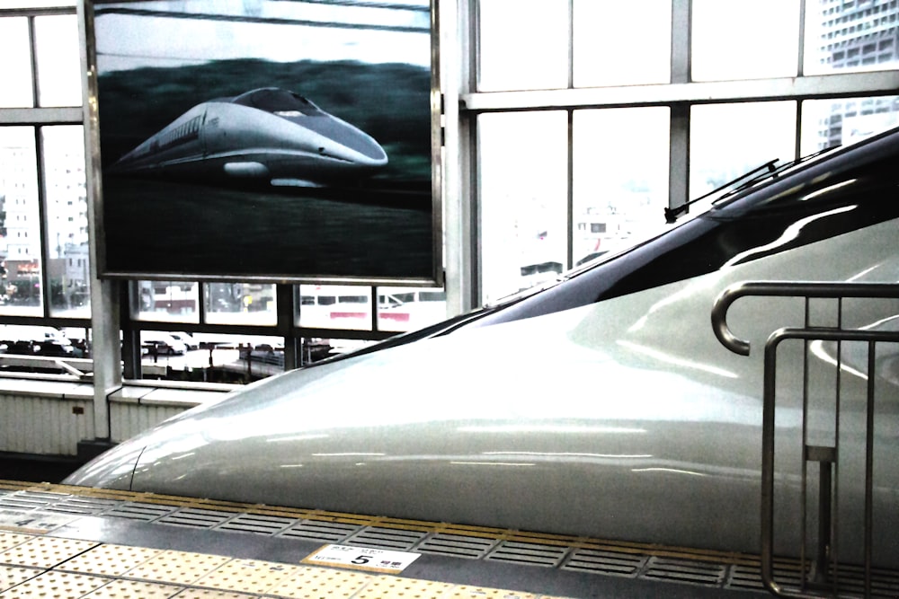 a bullet train sitting in a train station