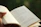 Close-up of a man reading the book outdoors surrounded by nature.