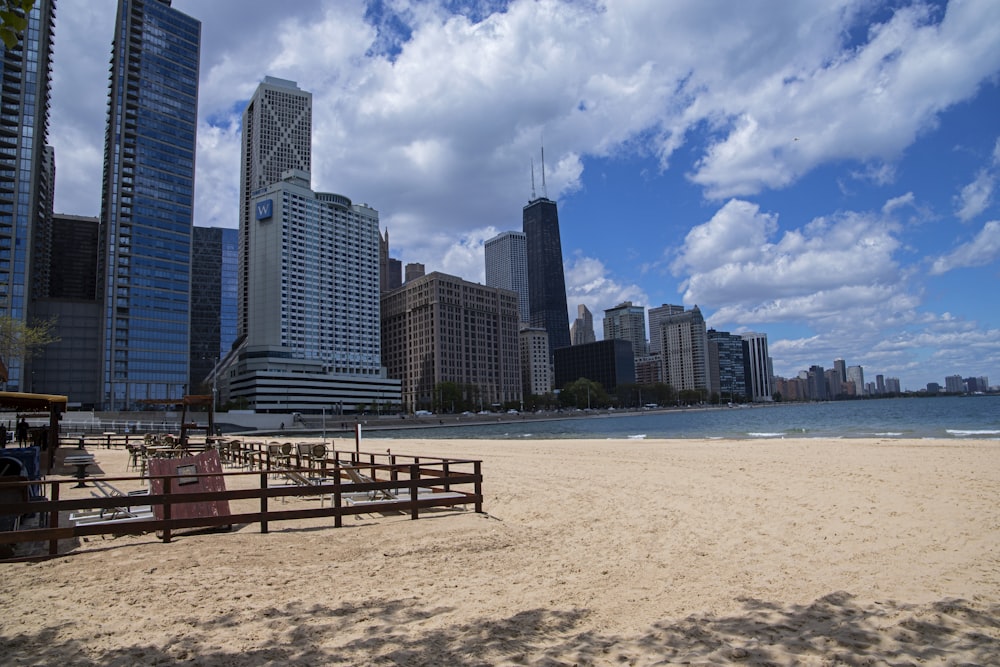 a sandy beach with buildings in the background