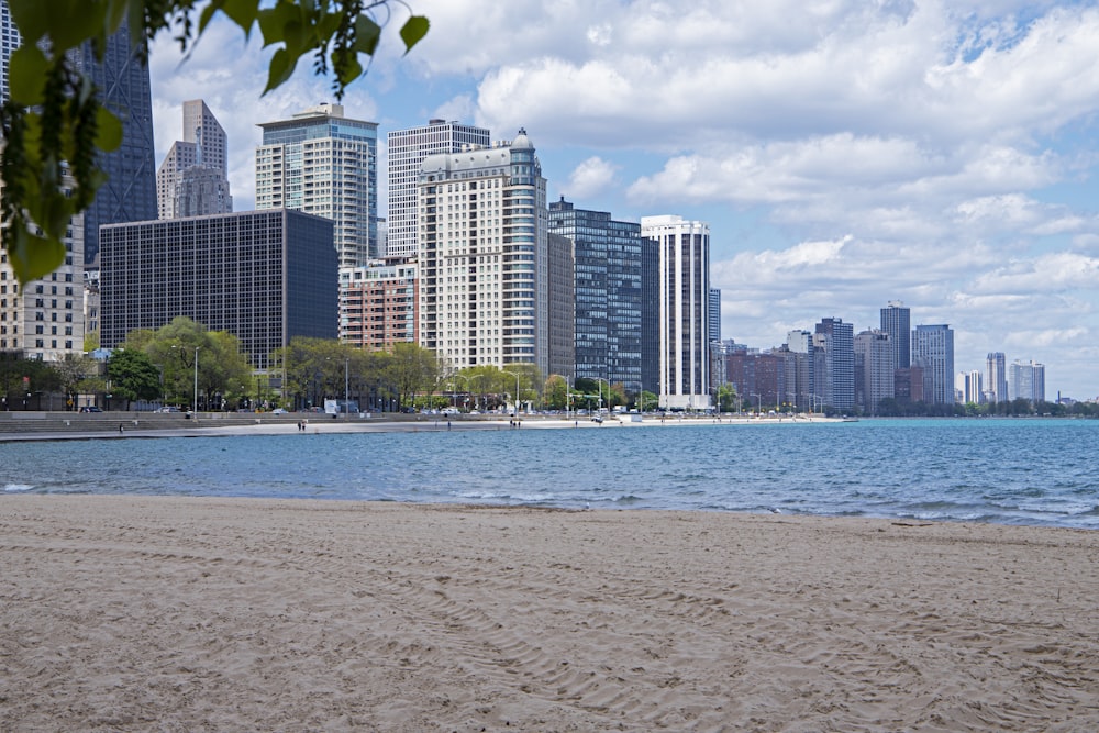 a sandy beach with buildings in the background