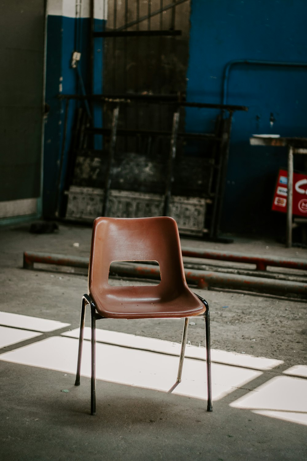 a brown chair sitting on top of a cement floor
