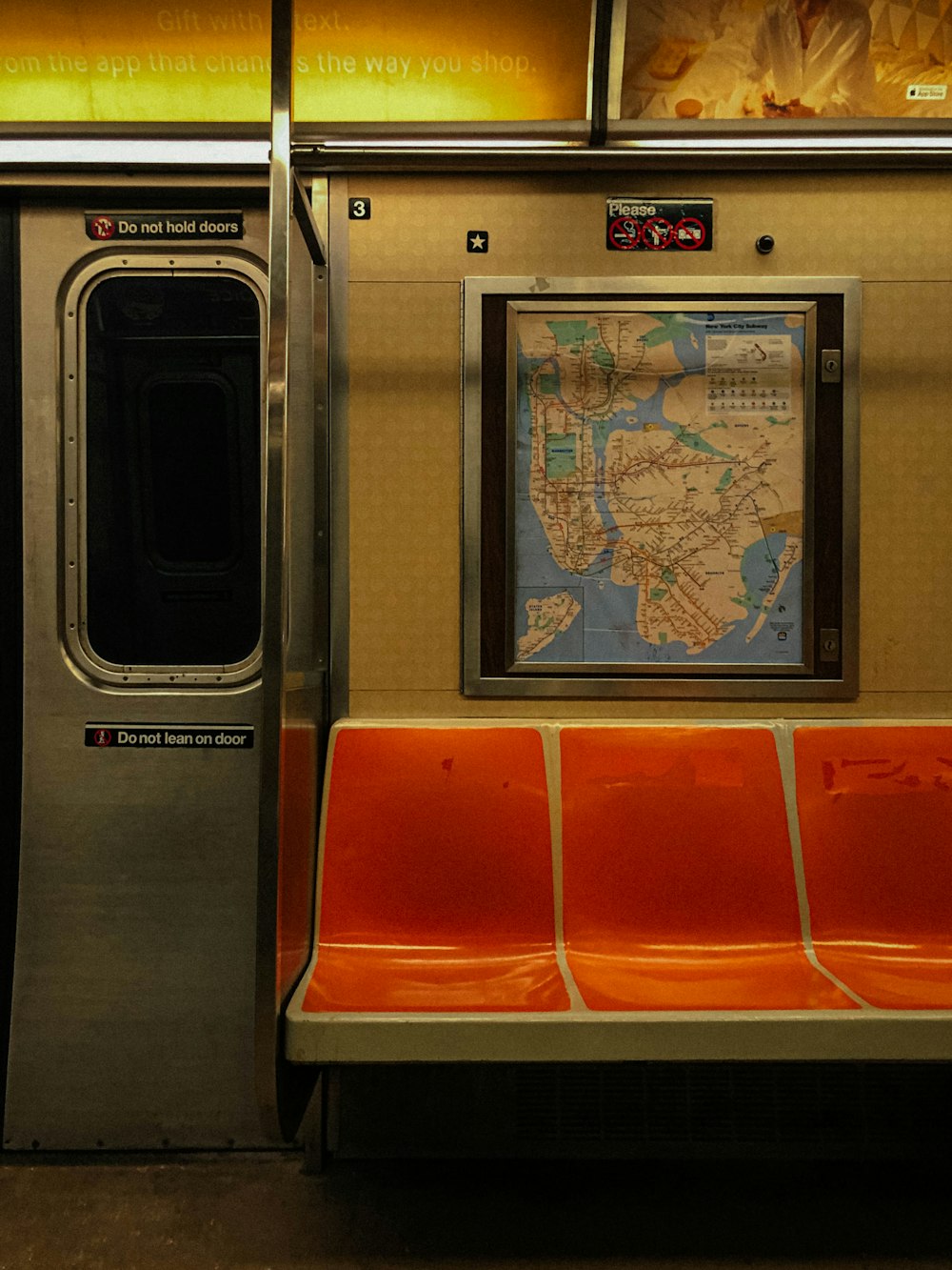 a subway car with a map on the wall
