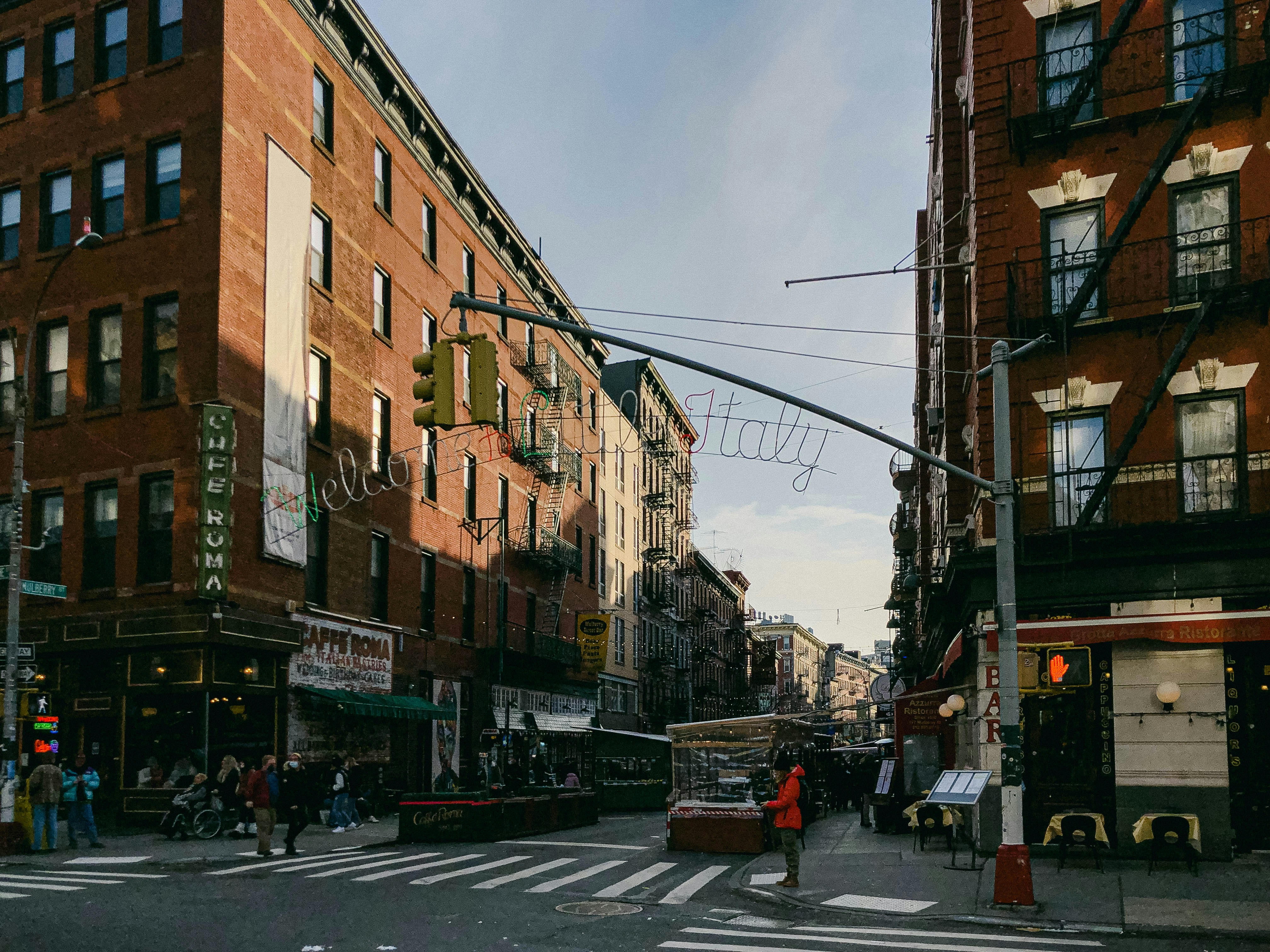 a busy city street with people crossing the street, 