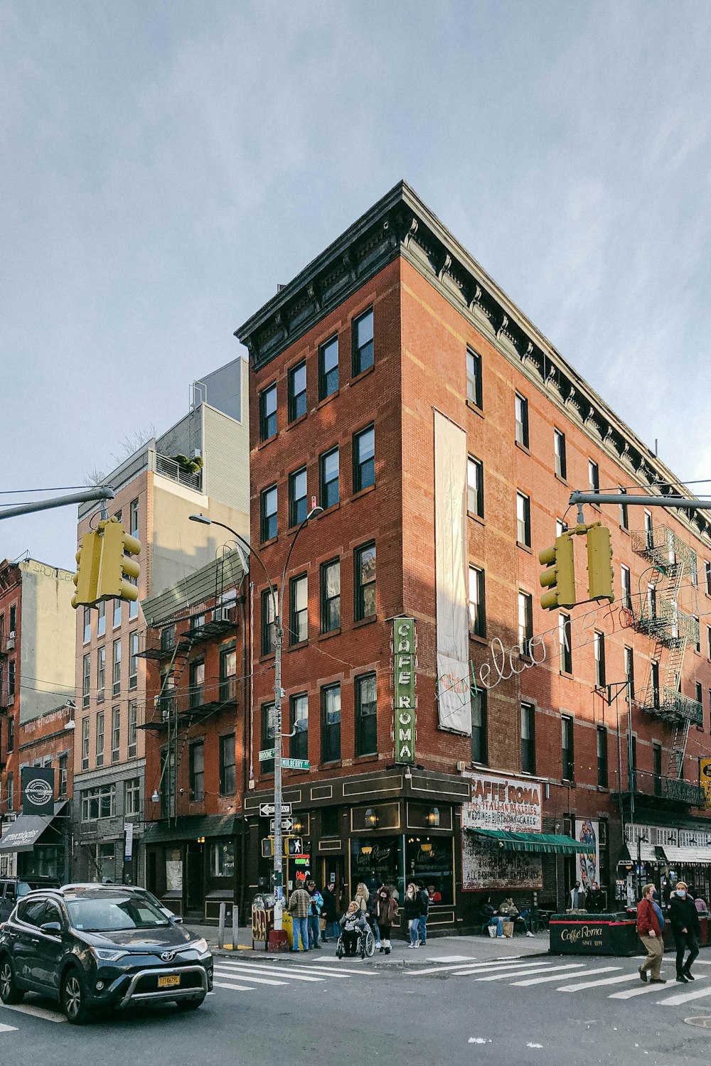 a large brick building on the corner of a city street